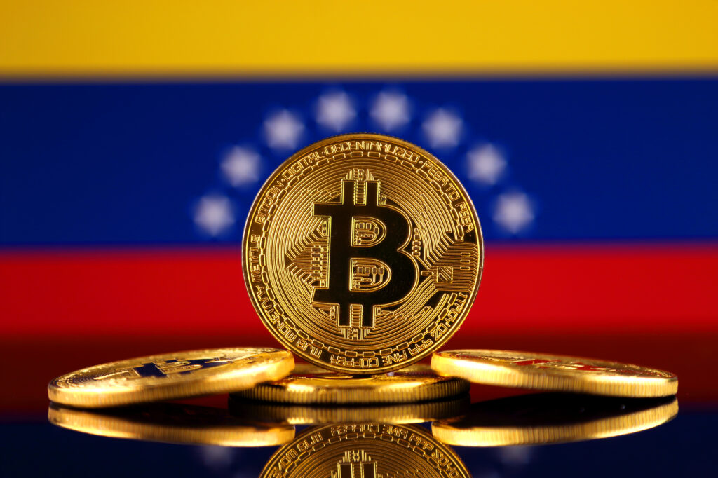 Physical version of Bitcoin (new virtual money) and Venezuela Flag.