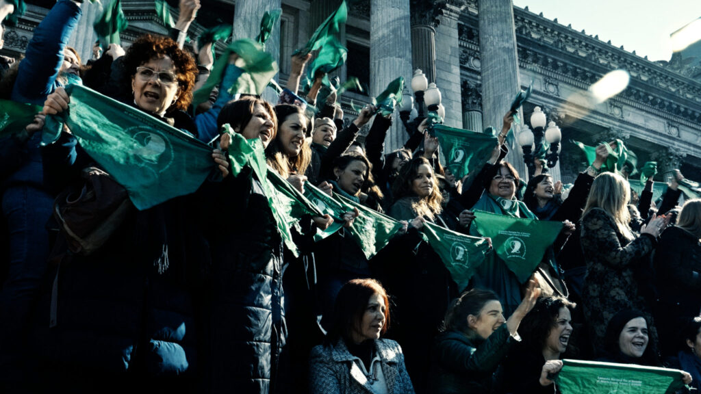 Protestors for legal abortion with green handkerchiefs