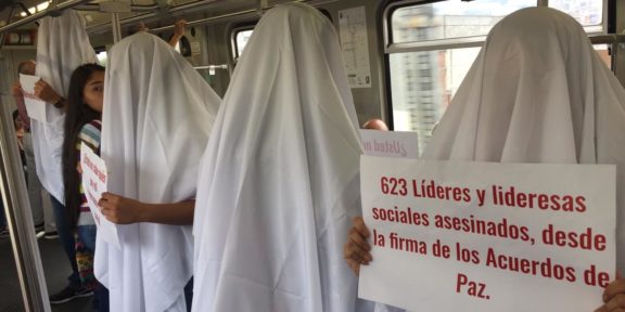 Demonstrators in white sheets are protesting the killings of social leaders in Colombia