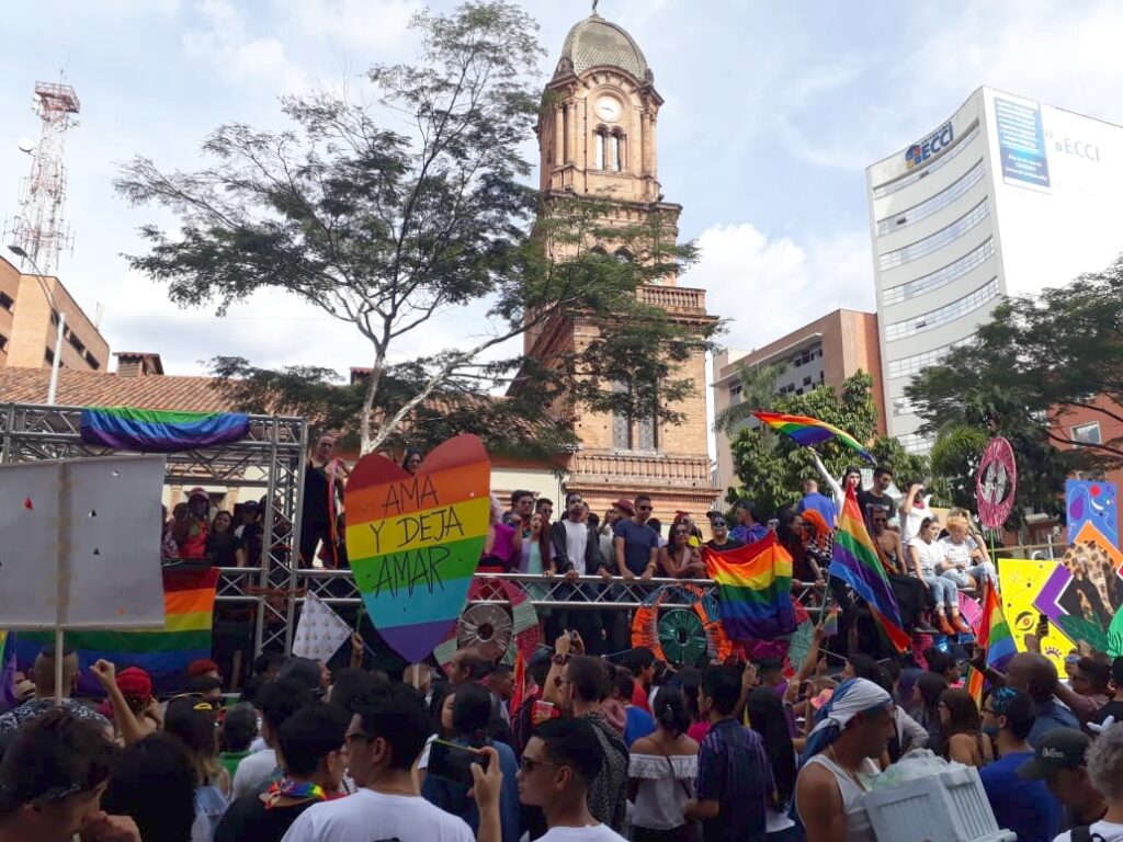 Medellin Pride parade float crowd flag